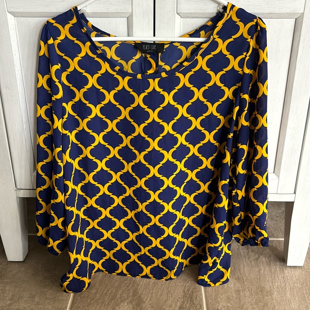 Peach Love..Woman’s blue and gold blouse with decorative buttons on back.